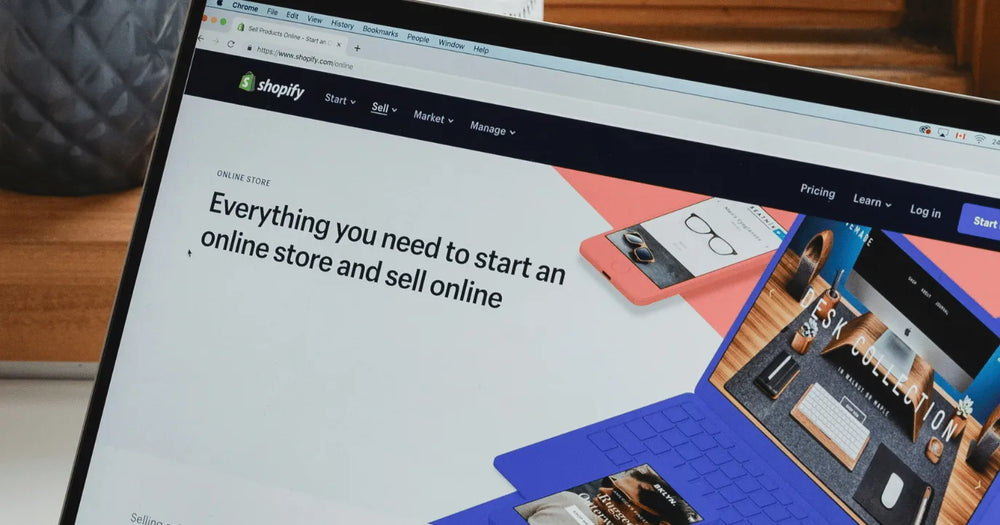 E-commerce agency professional working on a laptop with a Shopify website displayed on the screen.