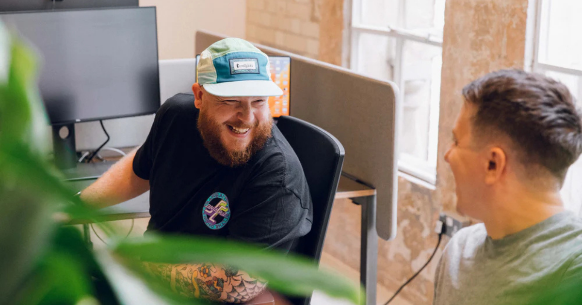 Two professionals collaborating in a Shopify agency office, working on ecommerce solutions