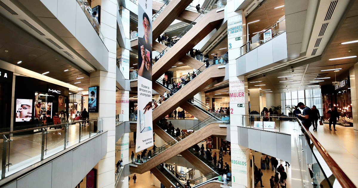 View of a shopping mall featuring diverse retail brands, representing the variety of businesses powered by the Shopify platform.